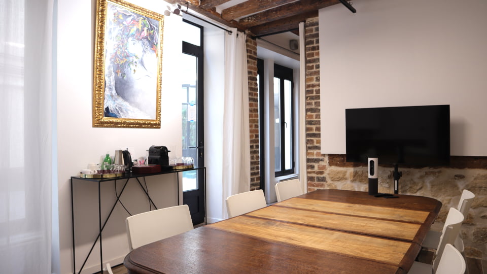 Salle de réunion pour 7 personnes avec écran, visioconférence et tableau blanc